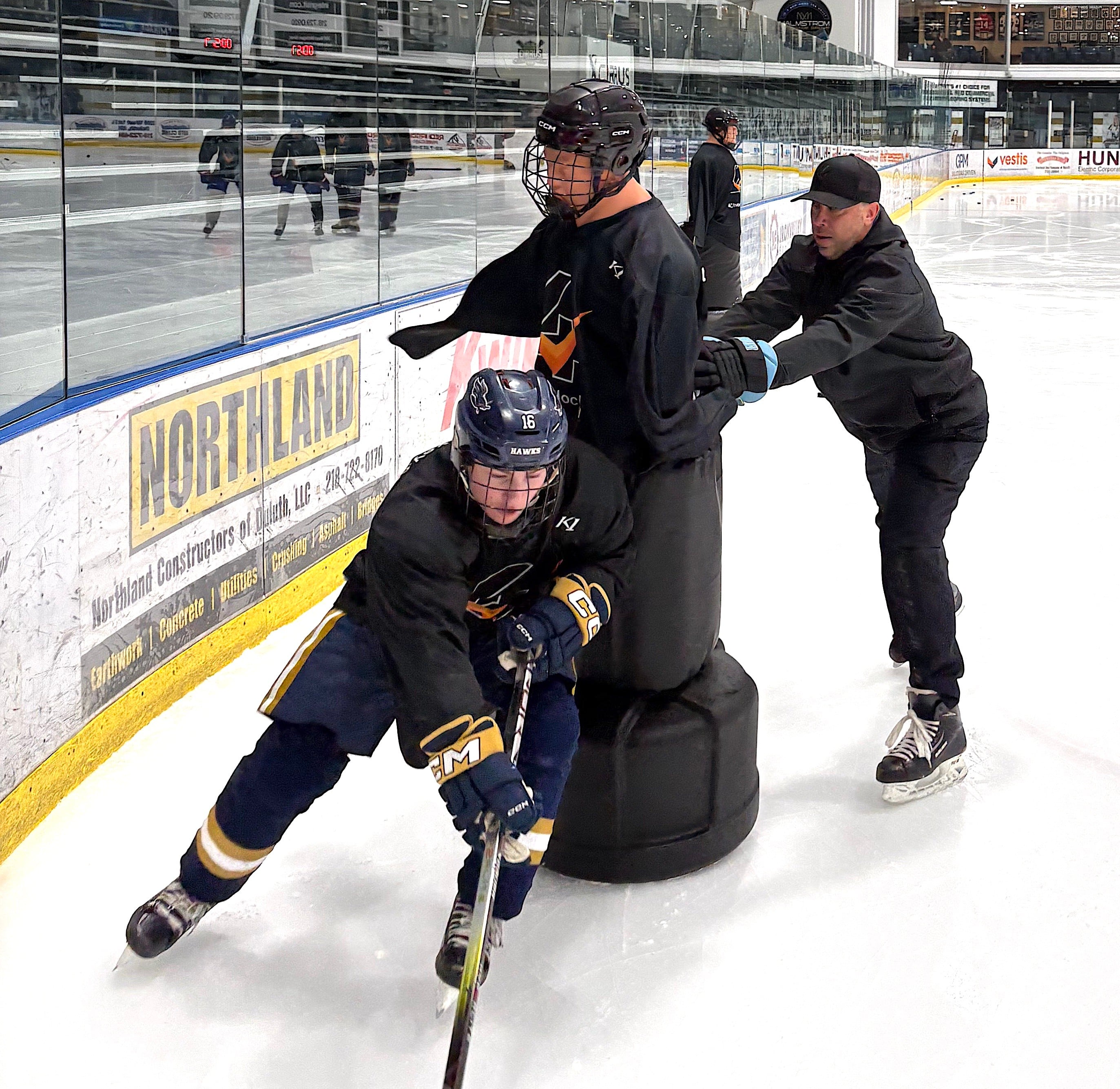 4Check Hockey player delivering a controlled check on a training dummy