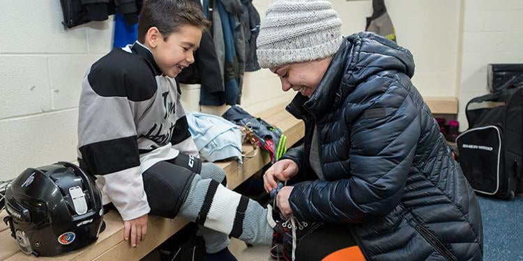 Mom lacing sons skates